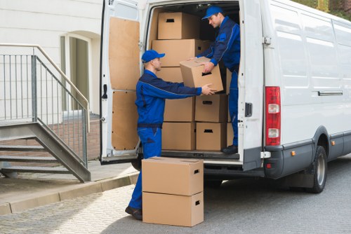 Professional movers handling furniture during a West Kensington same day move