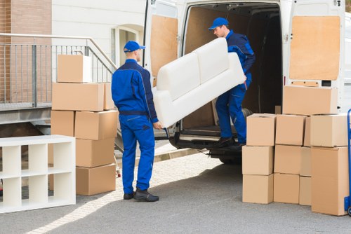 Professional movers handling furniture in a residential property