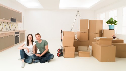 Professional movers loading furniture into a van in Westkensington