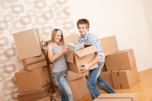 Professional movers wrapping household furniture safely